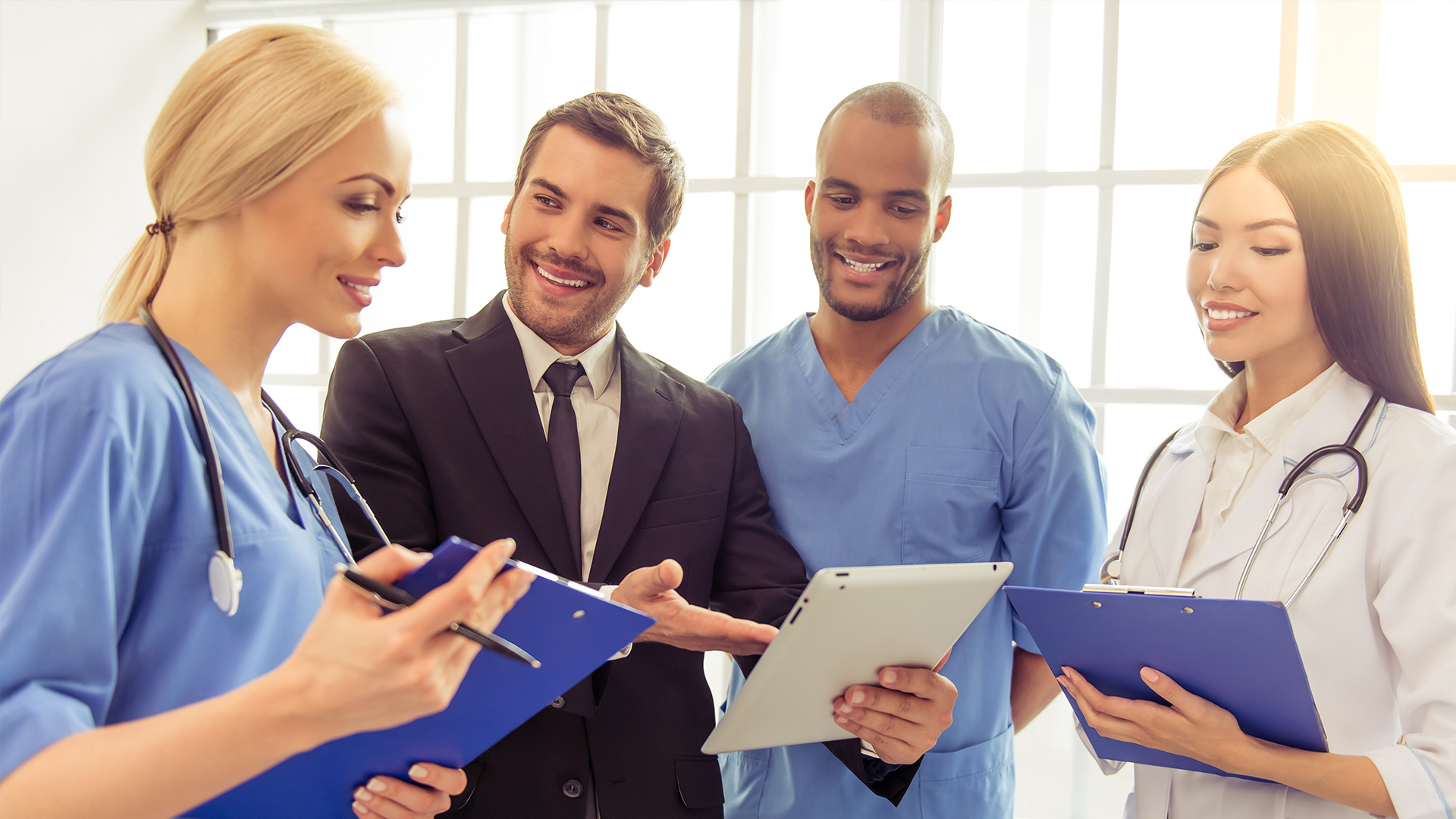 Photo of four medical professional with students