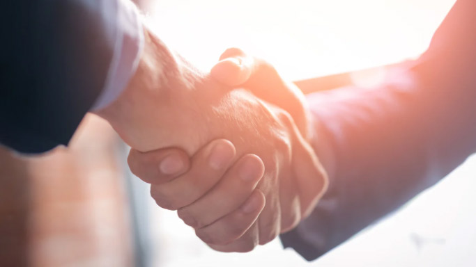 Image of two people shaking hands