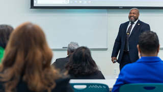 Photo of a faculty member at the front of a classroom