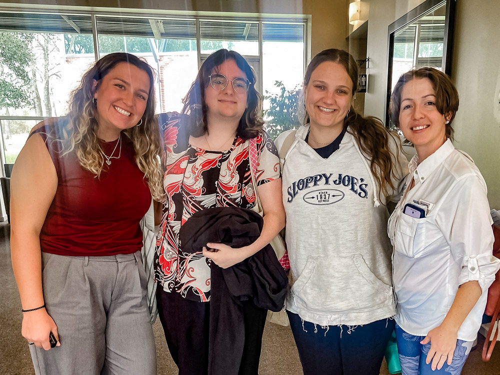 Four people pose for a photo at a soil health workshop in Houston.