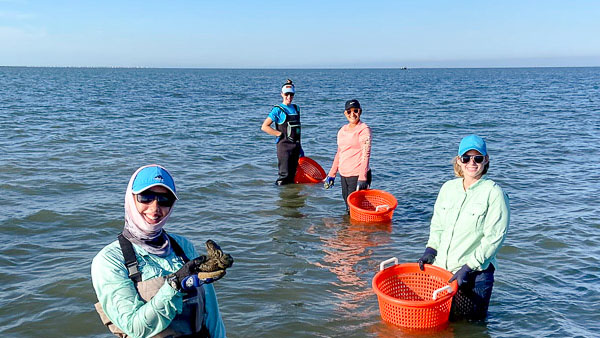 A group of people standing in bay water