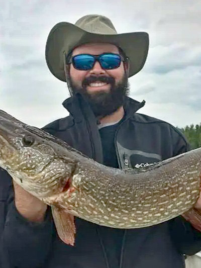 A person holding up a fish with both hands.