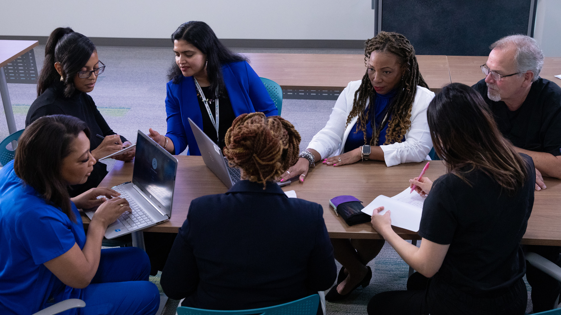 Photo of faculty around a conference table